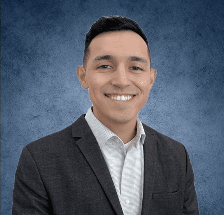 Young professional smiling in charcoal suit